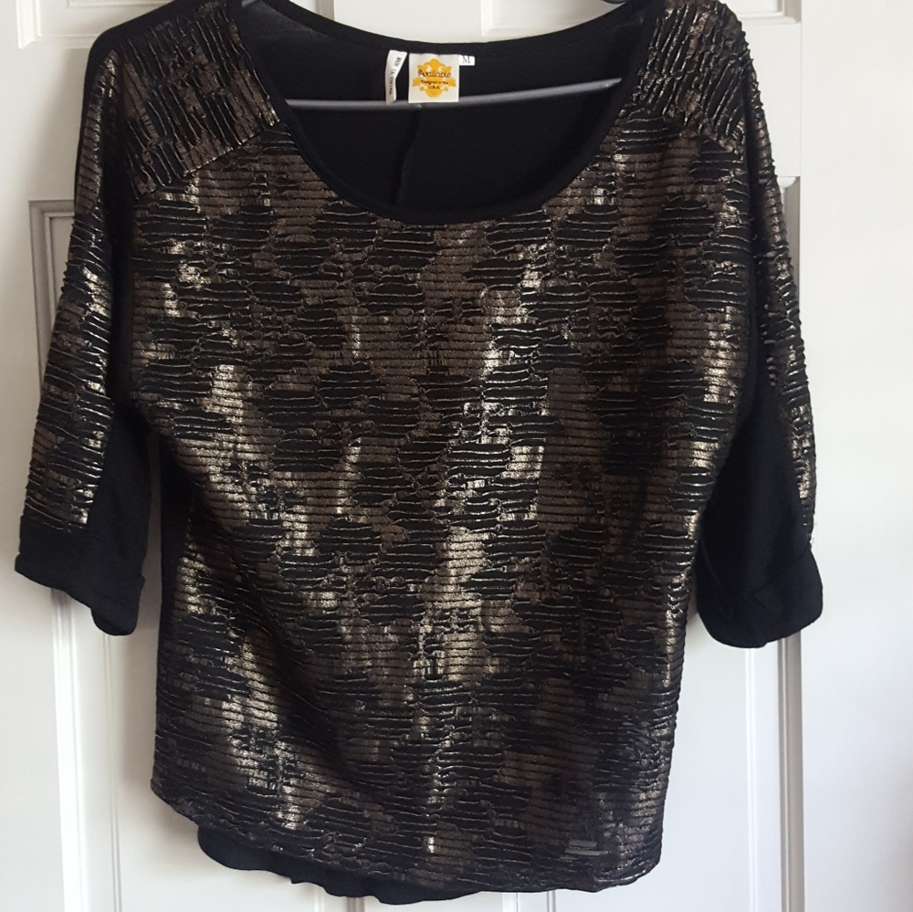 Available three quarter sleeve metallic top